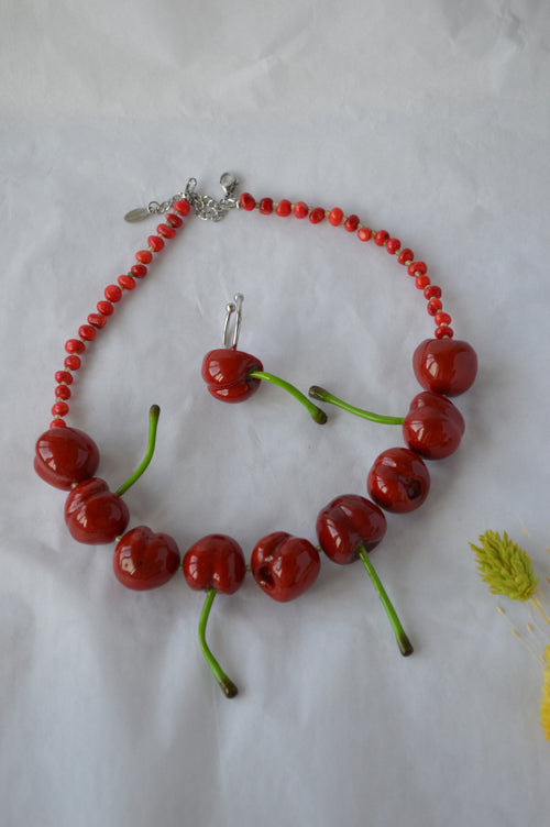 Necklace with cherry-shaped beads on a white background