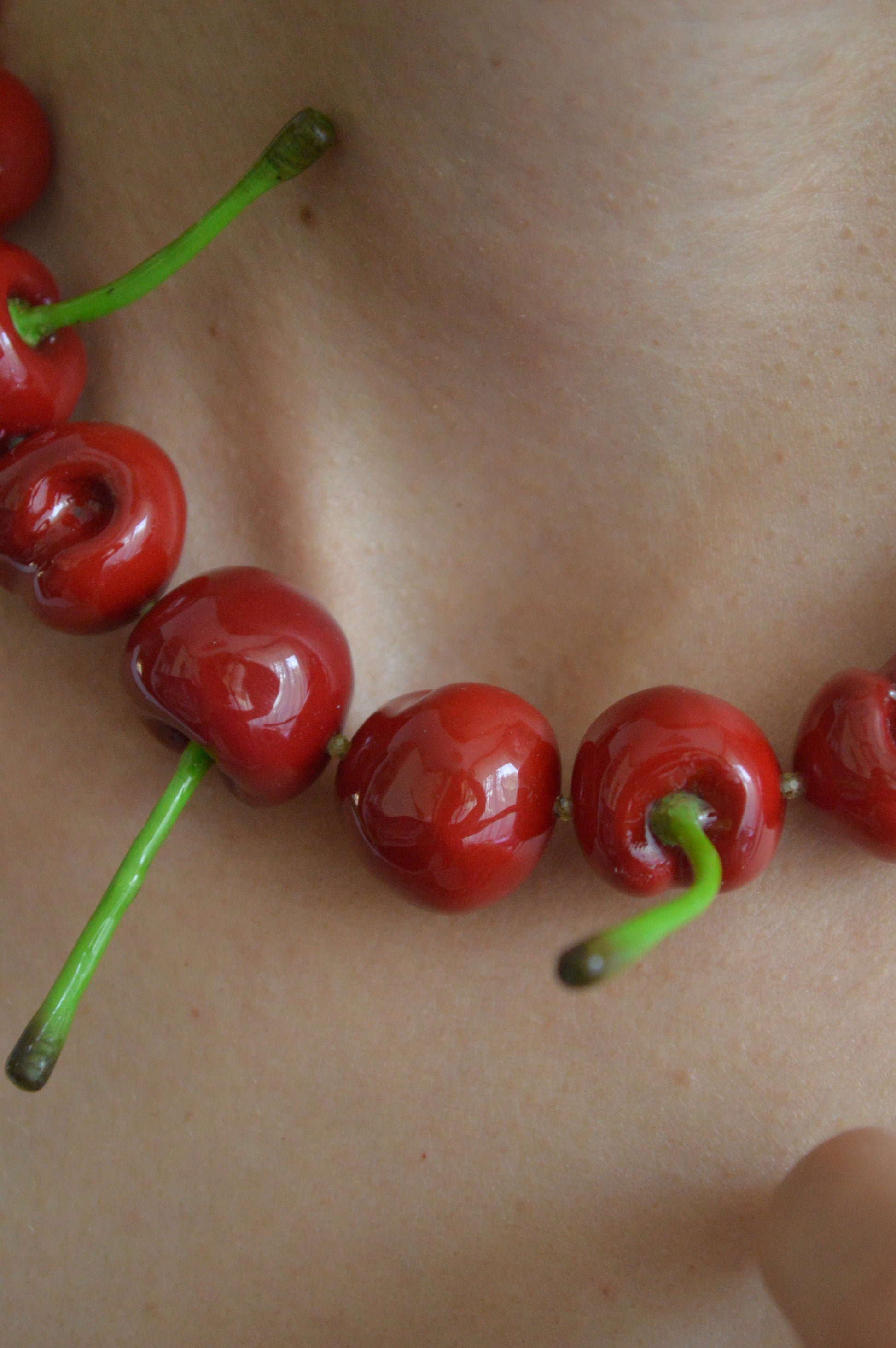 Close-up of cherries on a person's skin