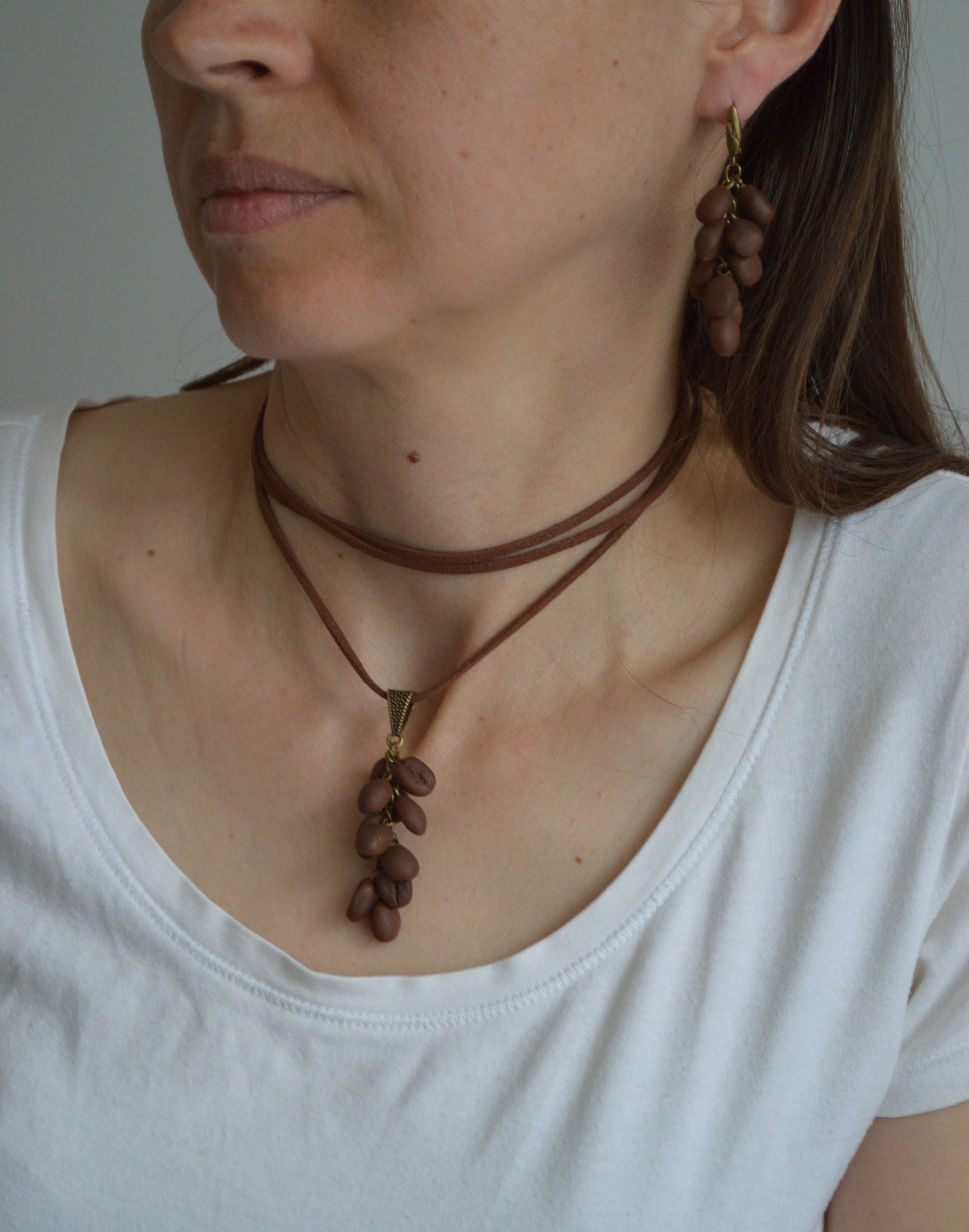 Woman wearing a necklace with a brown leather strap and pendant