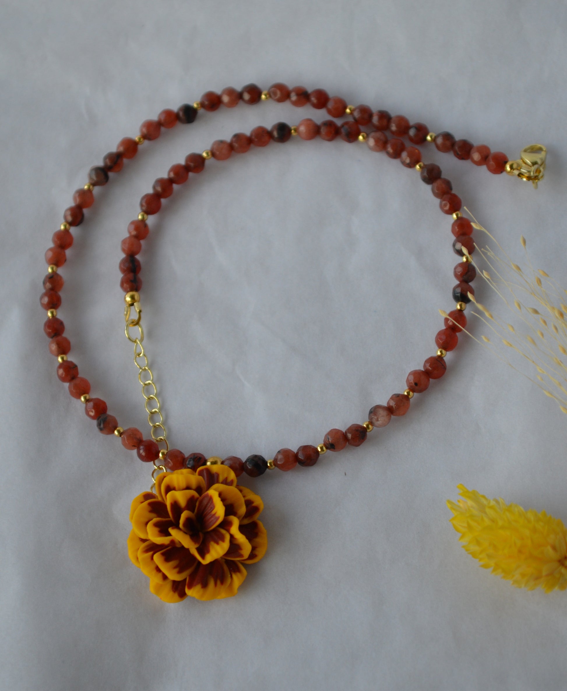 Necklace with a yellow flower pendant and a beaded agat chain