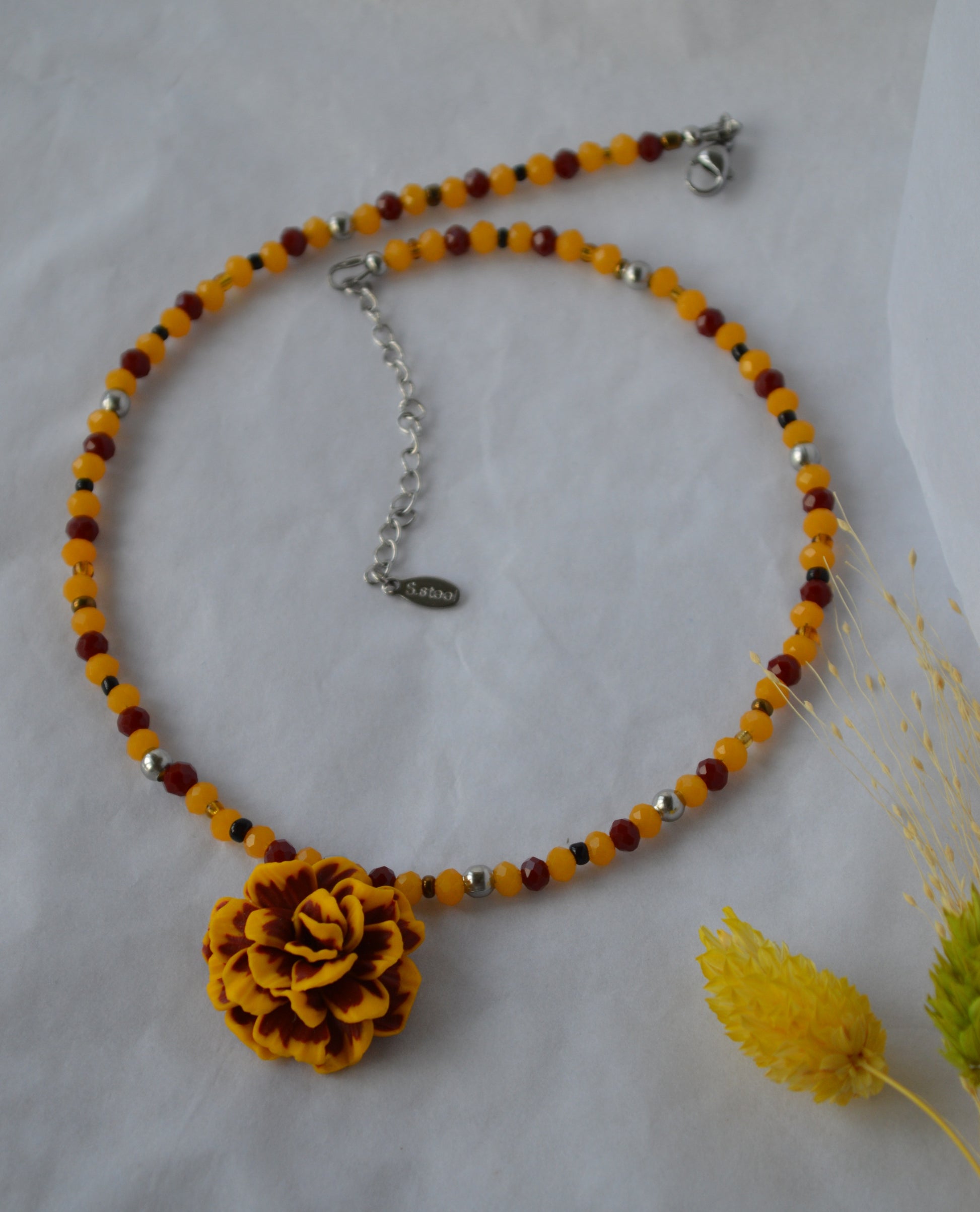 Necklace with a yellow flower pendant and a beaded chain